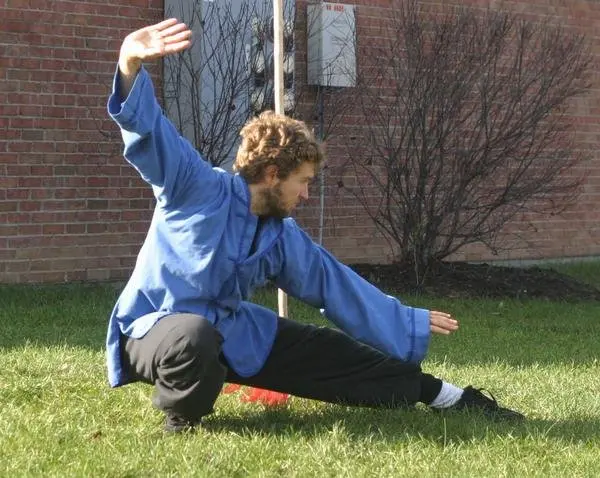 Dr. Micah Naziri practicing a low Northern Shaolin stance outdoors