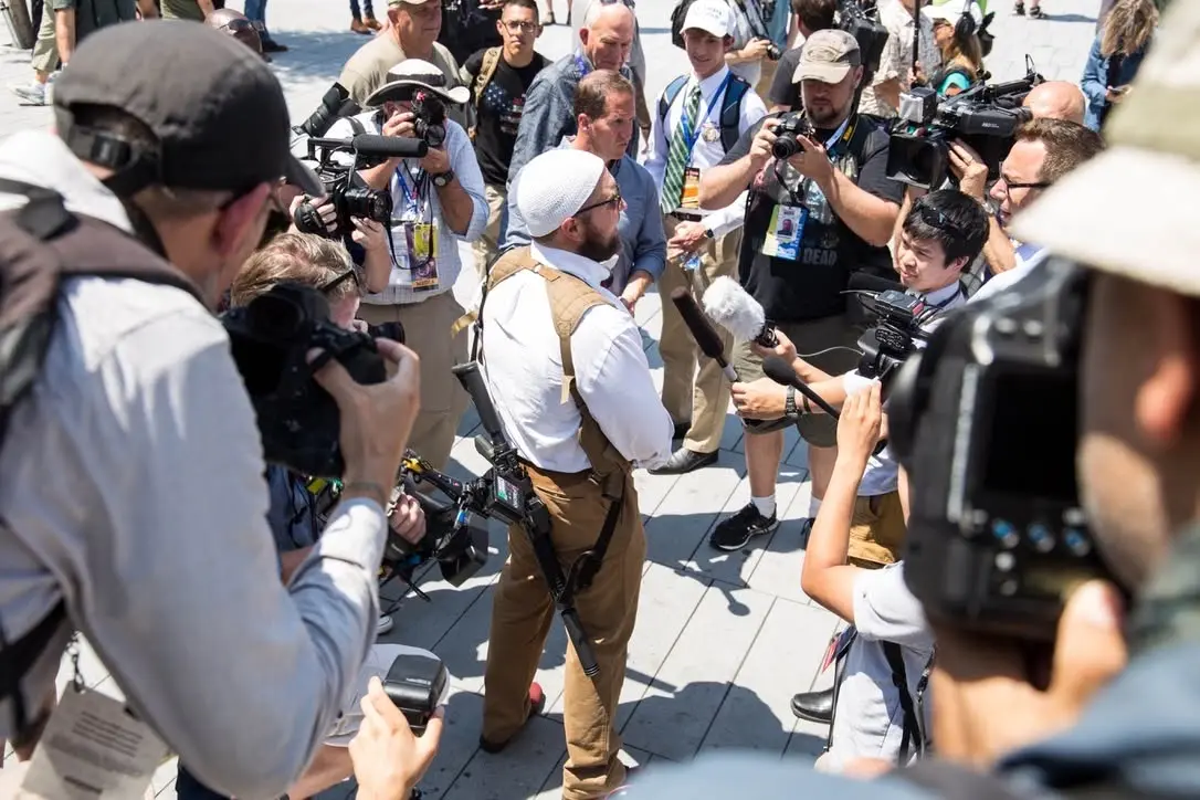 Dr. Micah Naziri speaking to press during a public community-defense presence