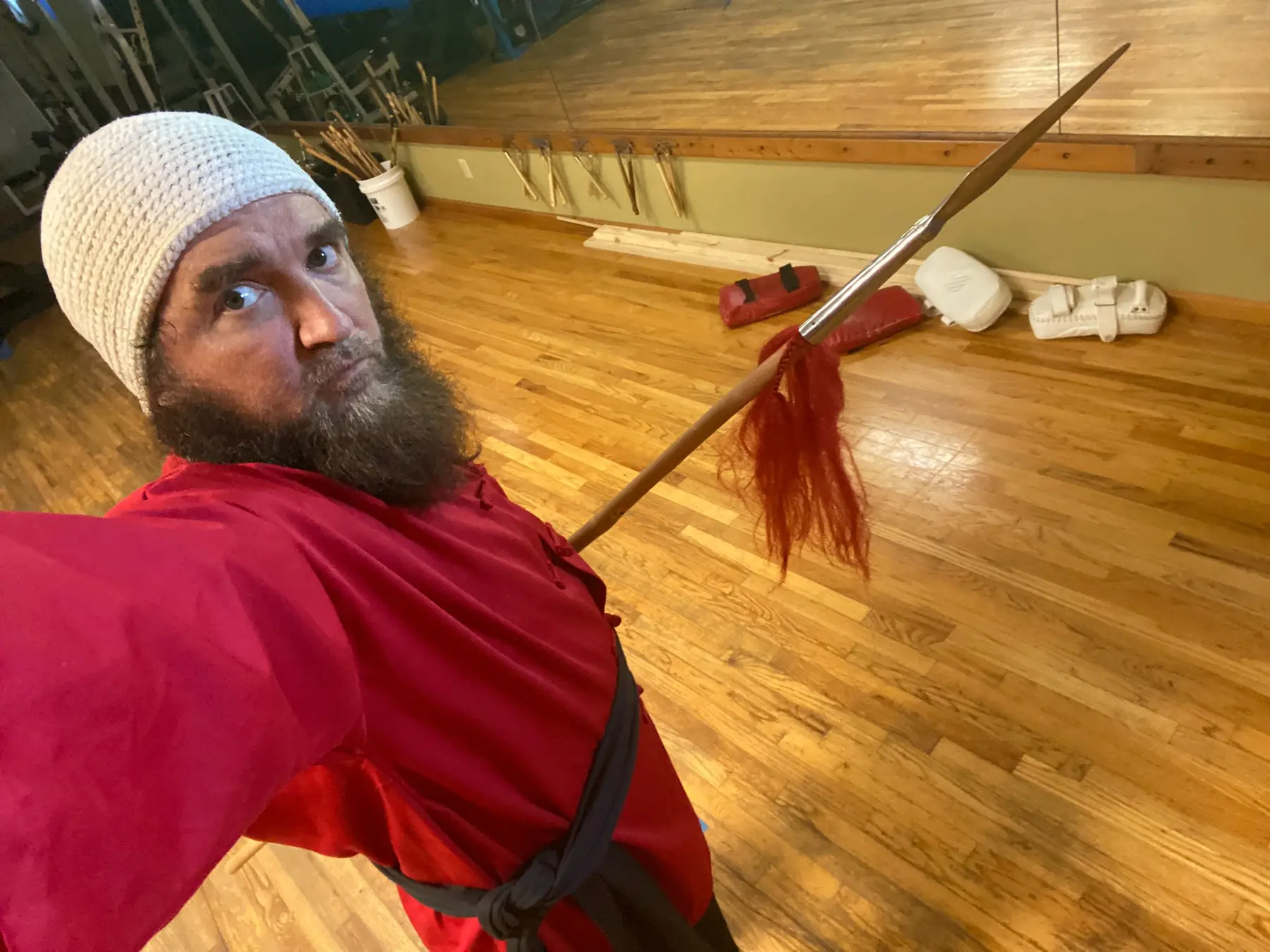 Dr. Micah Naziri holding a traditional Chinese long weapon
