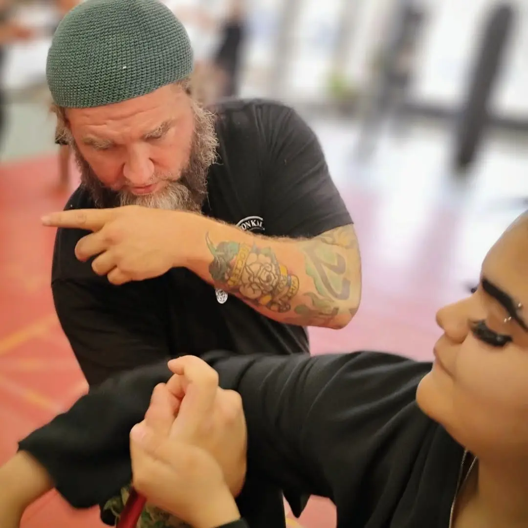 Dr. Micah Naziri teaching contact control to a training partner