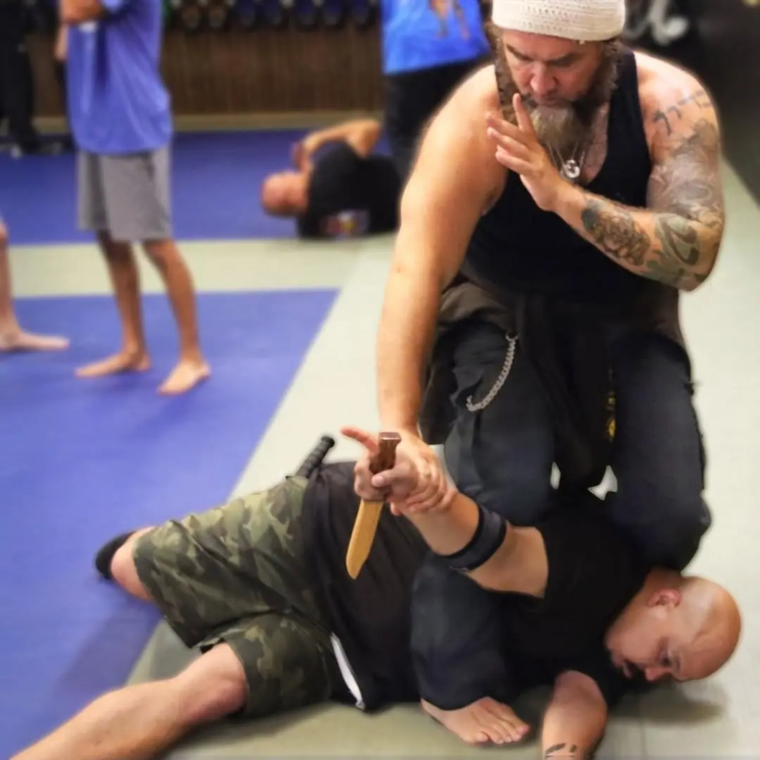 Dr. Micah Naziri demonstrating a Pencak Silat control against a training knife